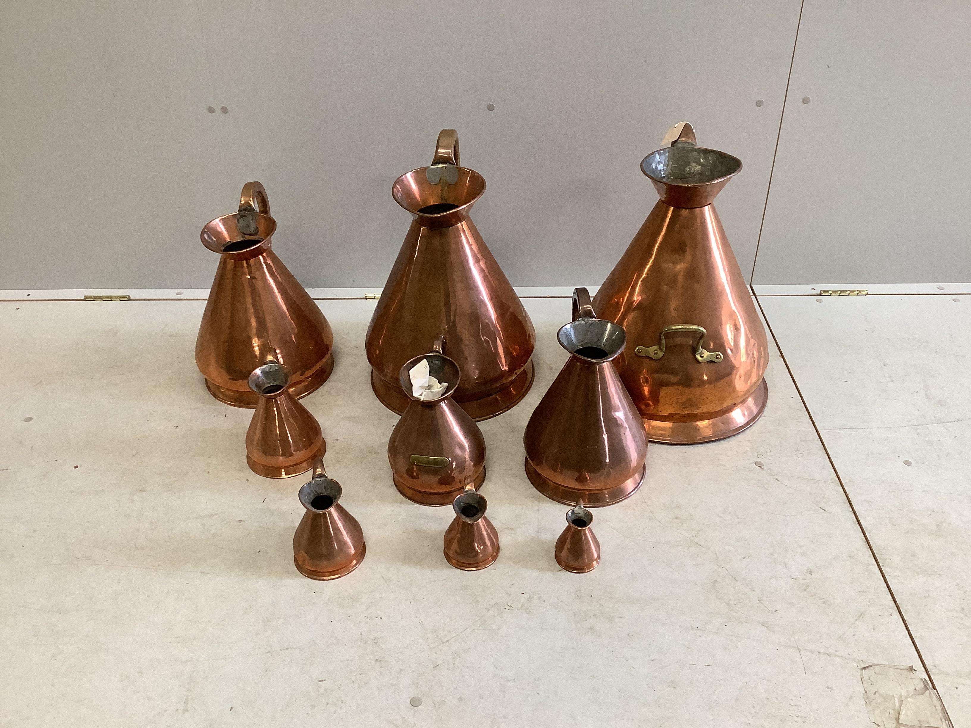 A matched graduated set of nine late 19th / early 20th century copper haystack measures, five gallons to a gill, largest height 50cm